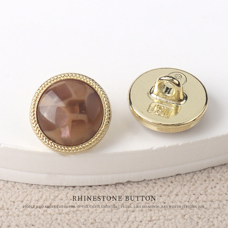 Brown resin-look 11mm button with gold rim and scalloped textured border