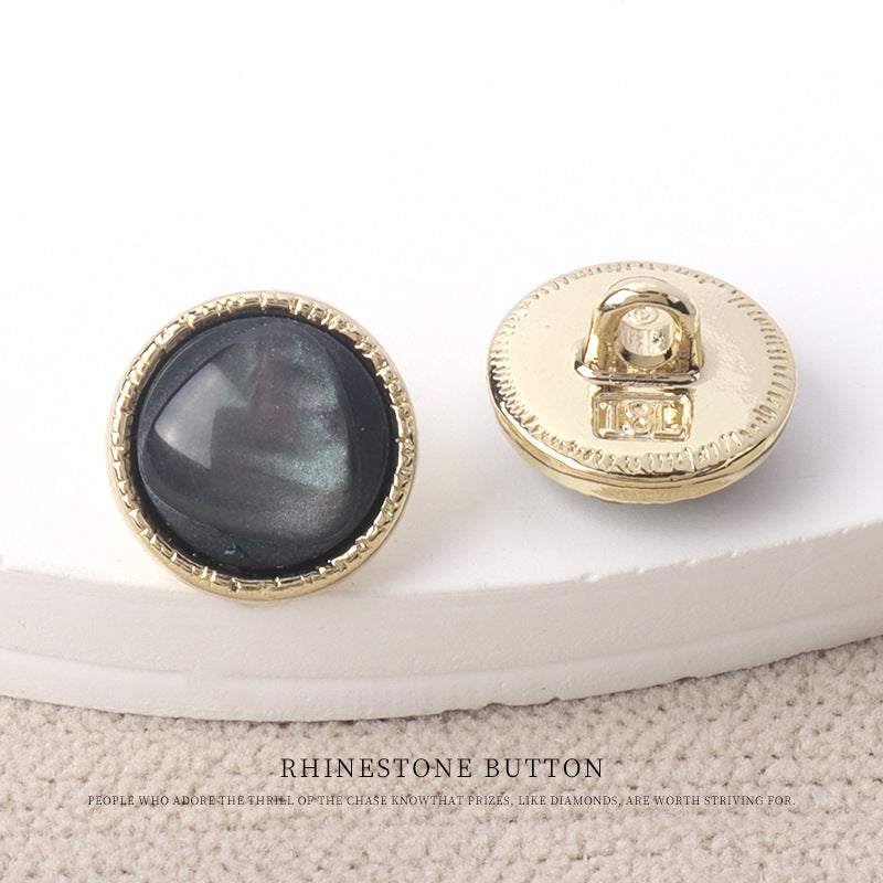 Black resin-look 11mm button front with gold rim and gold metal snap back