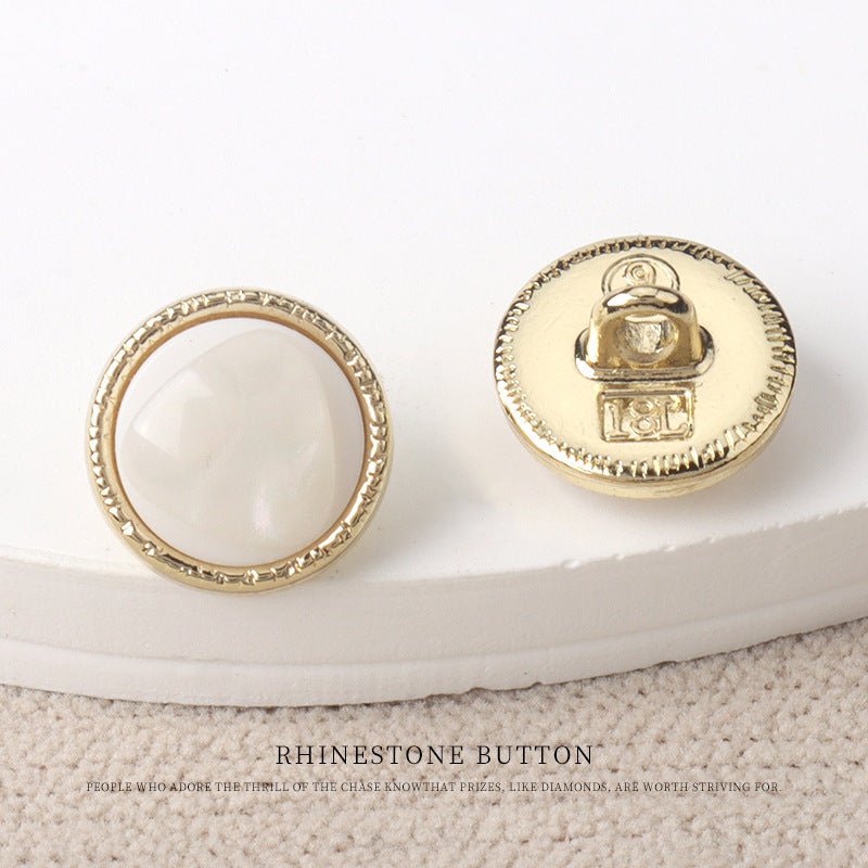 White resin-look 11mm button with gold rim and scalloped edge
