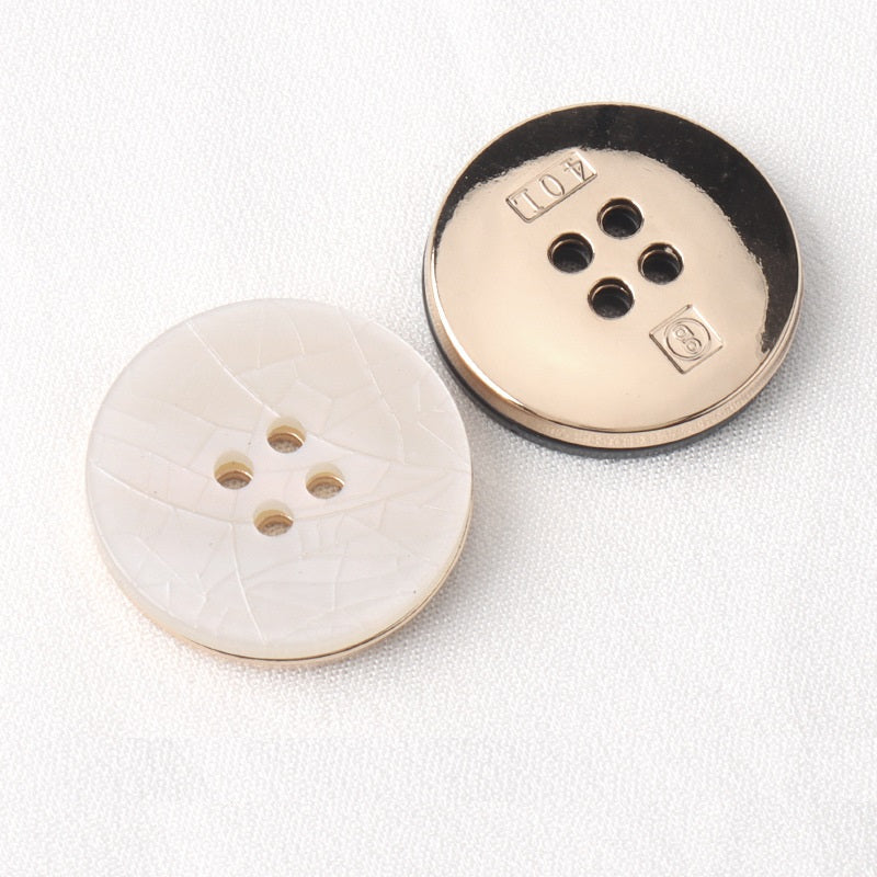 White and black cracked texture four-hole buttons, metal backs with stamp