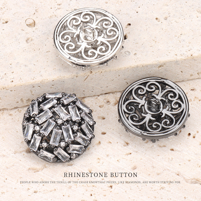 Two rhinestone buttons: silver filigree top, gunmetal dark base below