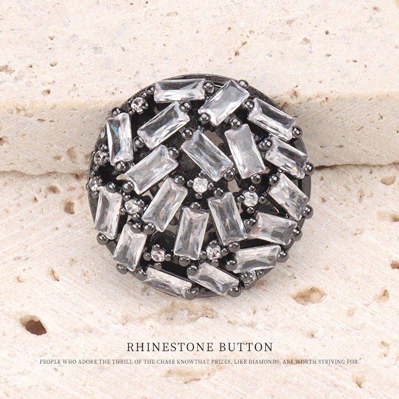 Gunmetal rhinestone button close-up with clear baguette stones and dark edges