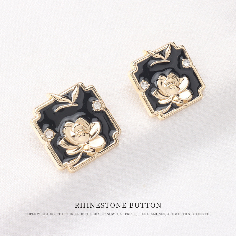 Square metal shank buttons, black enamel with raised gold lotus and crystal detail