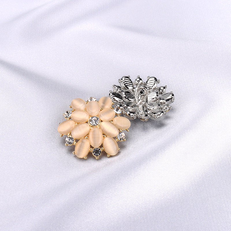 Gold 27mm crystal rhinestone button with oval opal-like stones and round center gem