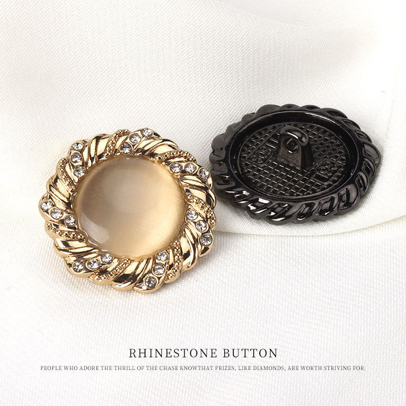 Gold and black round cat’s-eye buttons, reverse side with metal shanks and rim stones
