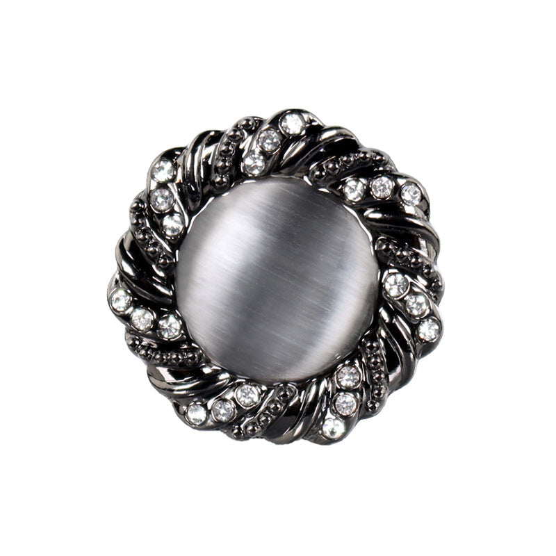 Black round cat’s-eye button with crystal rhinestones, metal rim, metal shank