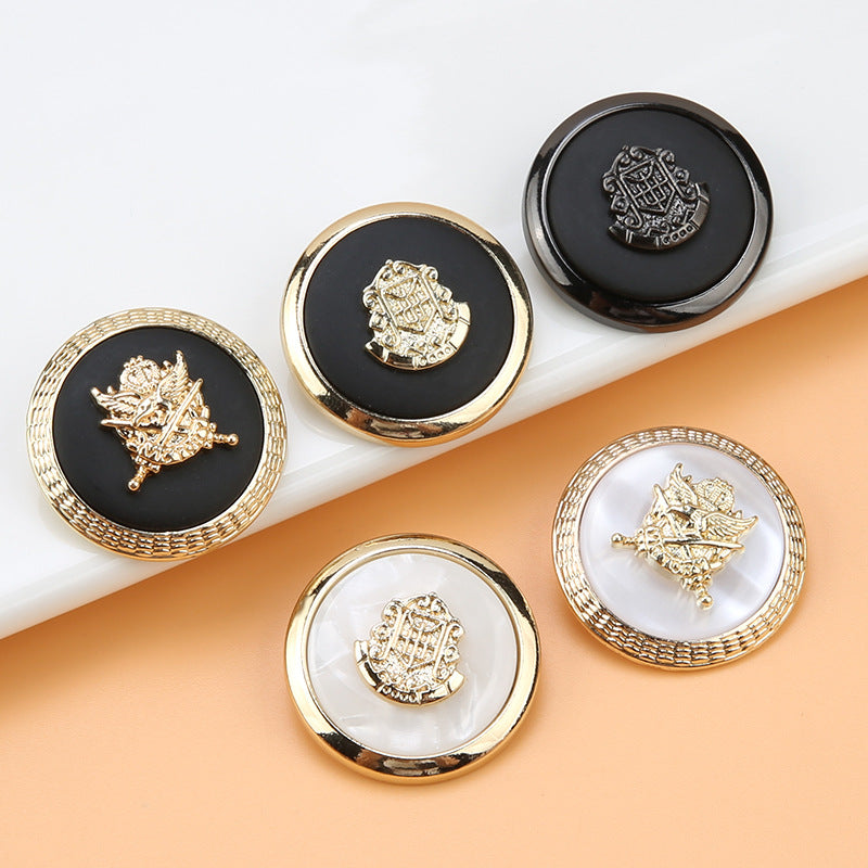 Round resin button, black center with gold anchor-shield crest and textured gold rim