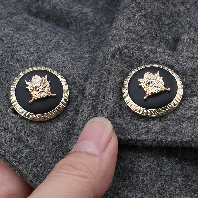 Round buttons on dark felt: gold anchor-shield emblem on black resin, textured gold edging