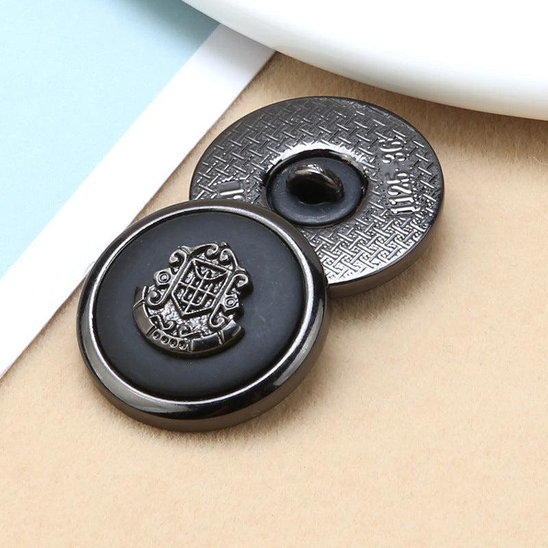Round buttons with metal shank: black resin face and gold anchor-shield crest with textured rim