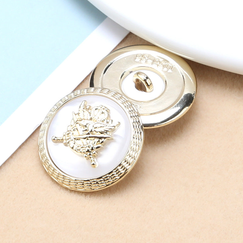 Pair of round resin buttons: white fronts with gold anchor-shield emblem and gold metal shank