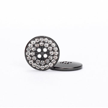 Round gunmetal four-hole button with clear rhinestone border and dark metal center