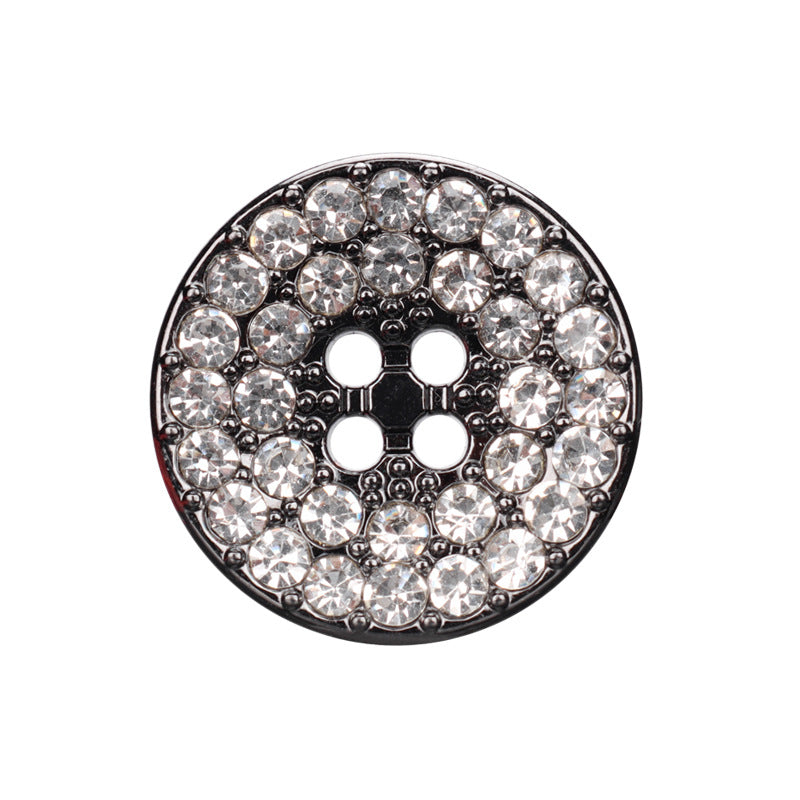 Round gunmetal four-hole rhinestone button, clear stones around the metal face