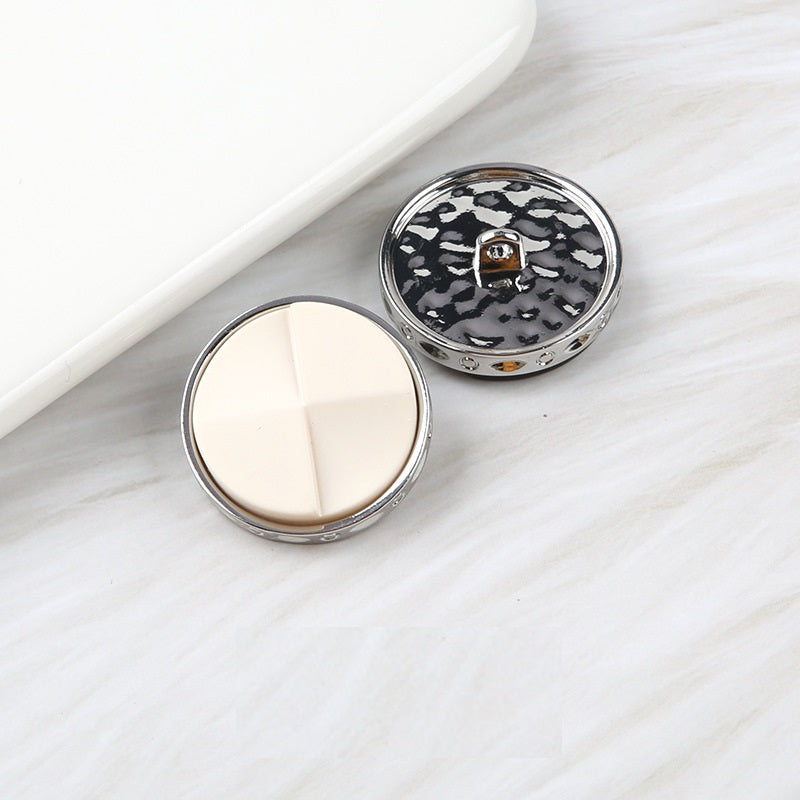 Fan-shaped two-tone resin buttons: off-white and black speckled, metal shank
