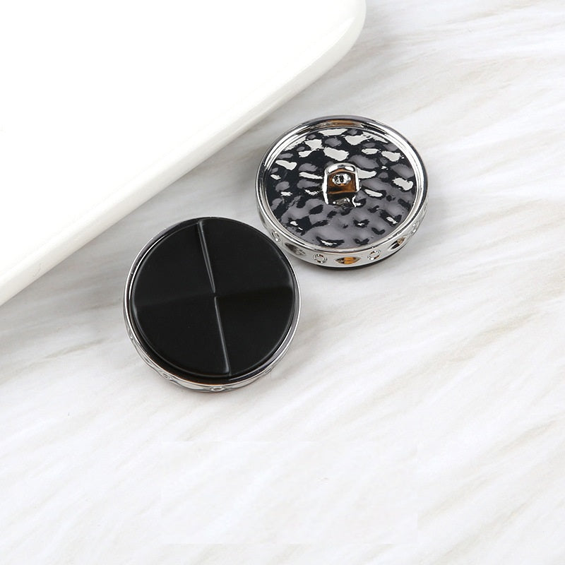 Fan-shaped two-tone resin buttons: solid black and black speckled, metal shank