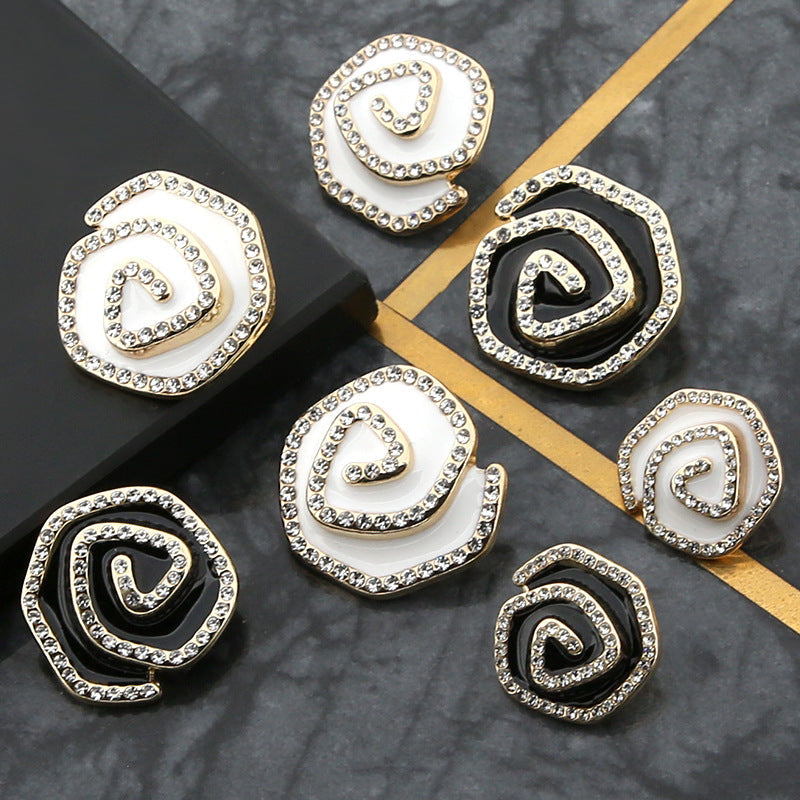 Curved metal buttons with rhinestone trim, mixed black and white enamel, gold-tone settings
