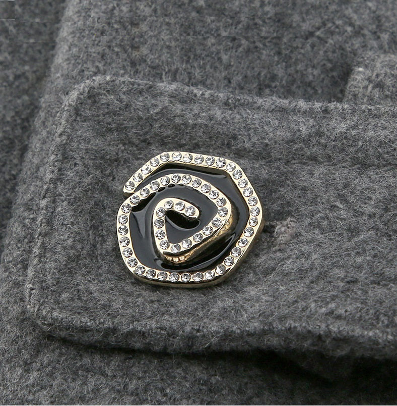 Single curved metal button with rhinestone border, black enamel center, gold-tone rim
