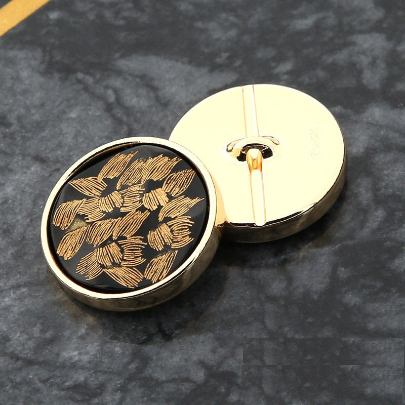 20mm round black button with gold floral front and gold-tone back