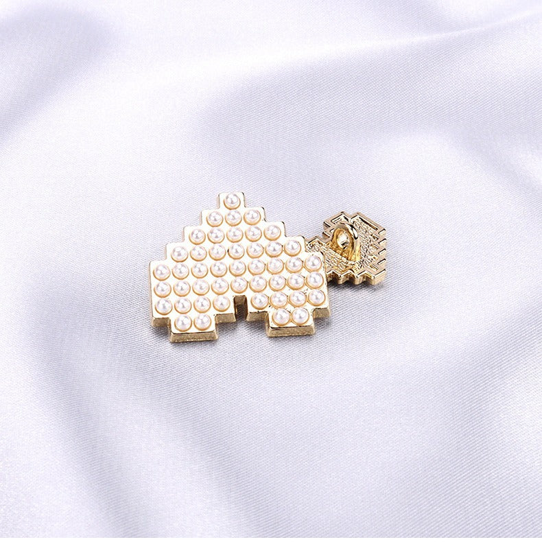 Small heart-shaped pearl button with gold-tone shank