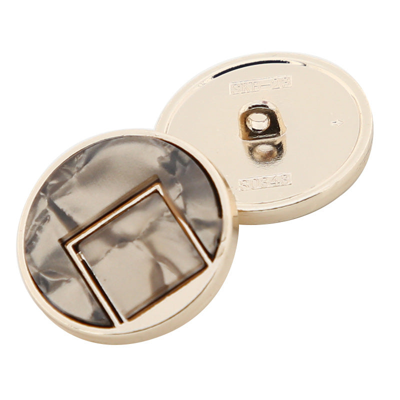 White round button face with square resin inset and metal shank, back view, gold-tone