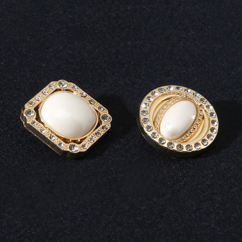 Square and round gold-tone shank buttons with pearl-look center framed by rhinestones