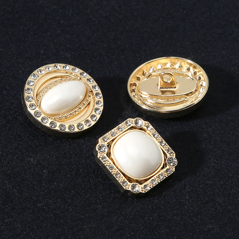 Gold-tone shank buttons with pearl-look front and rhinestone edging; one back visible