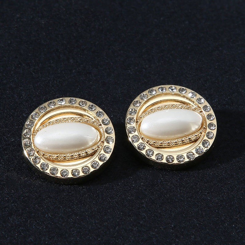 Pair of gold-tone round shank buttons with rhinestone border and pearl-look center