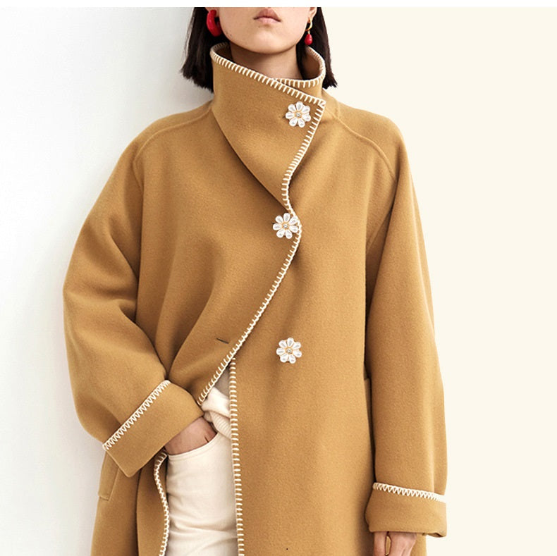 Floral pearl button detail with crystal center on children’s coat collar