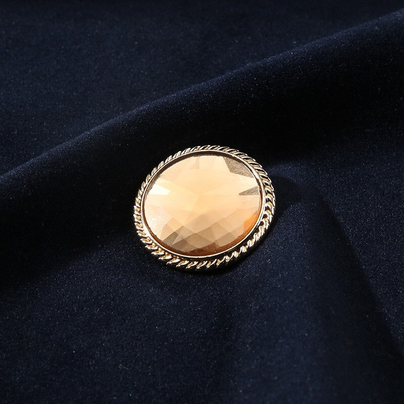 Light brown glass shank button with gold metal frame, round faceted 25mm