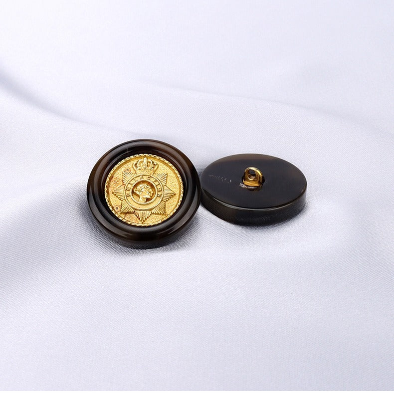 Black round button front and back view with gold emblem and metal shank loop