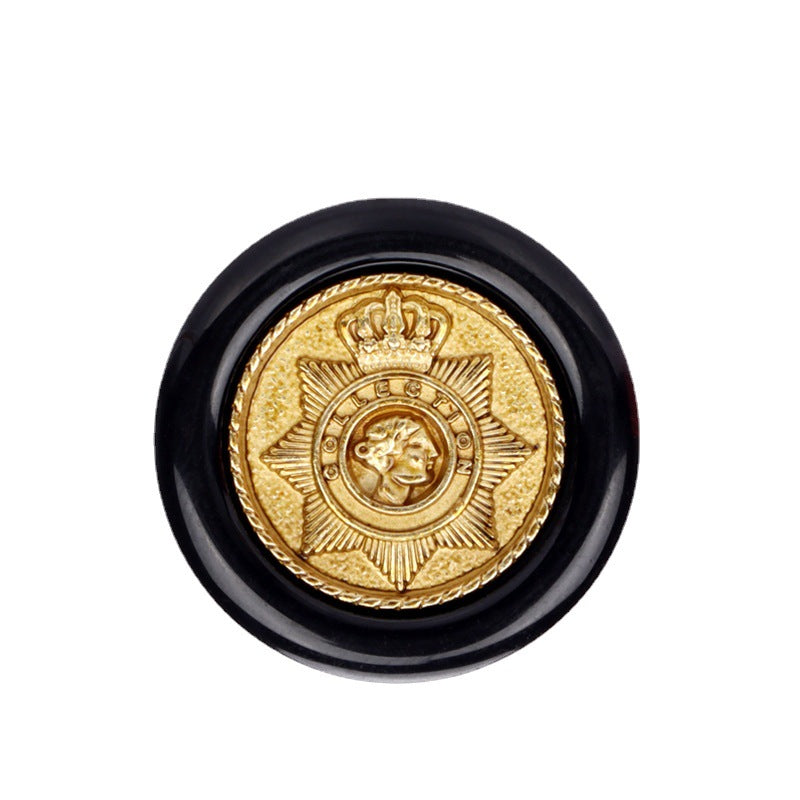 Black round resin button with gold crown star crest and metal shank