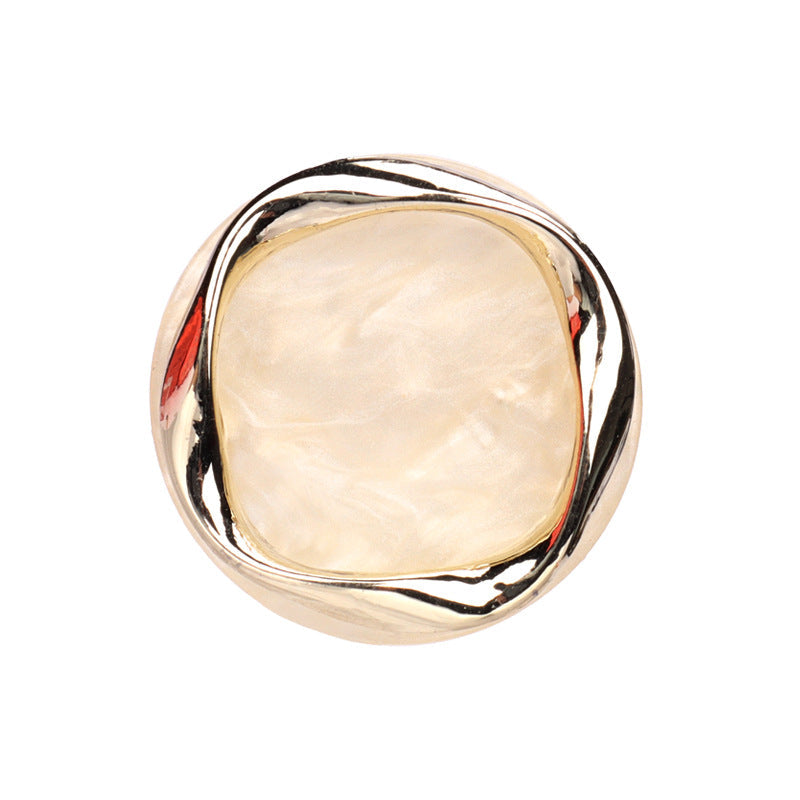 Beige resin shank button with metal rim, round, flat back visible