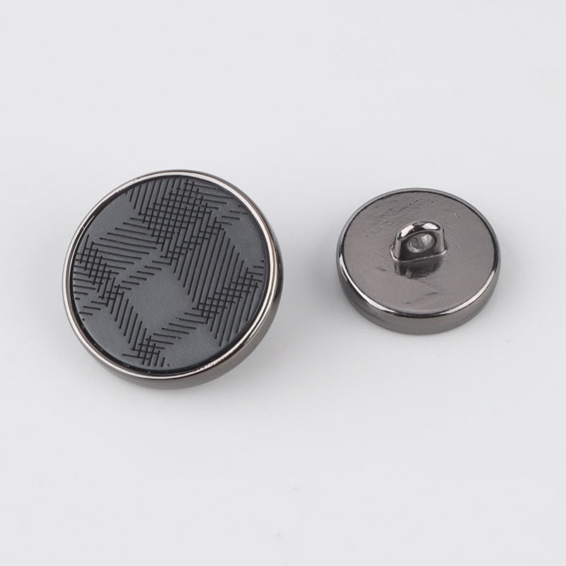 Round resin metal shank button front, dark circular face with laser-engraved lines