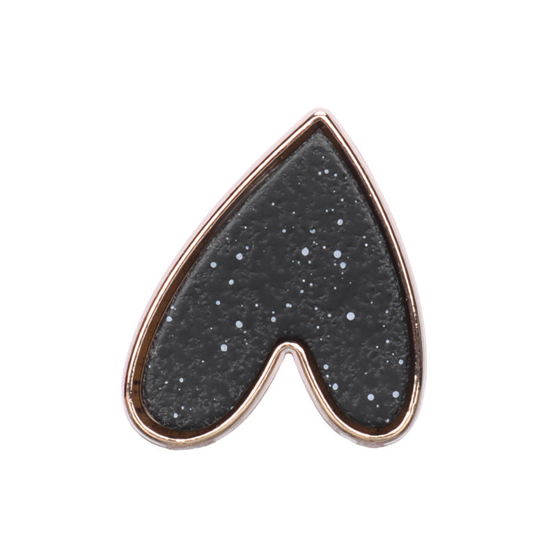 Heart-shaped metal shank button, black speckled front with gold-tone border