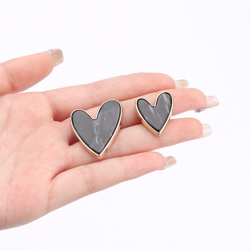 Heart-shaped metal shank button, dark gray-black heart on rose-gold outline
