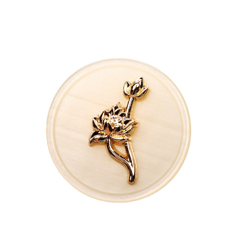Beige round resin button with gold-tone rose-floral shank detail