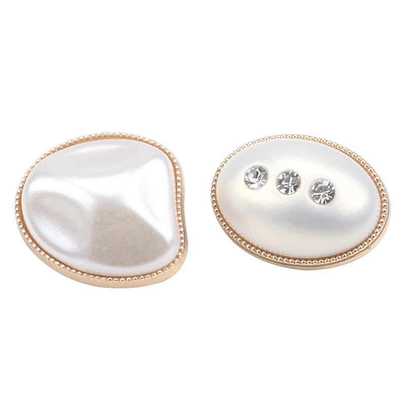 Two oval pearl-look buttons: one plain, one with gold bezel and three rhinestones