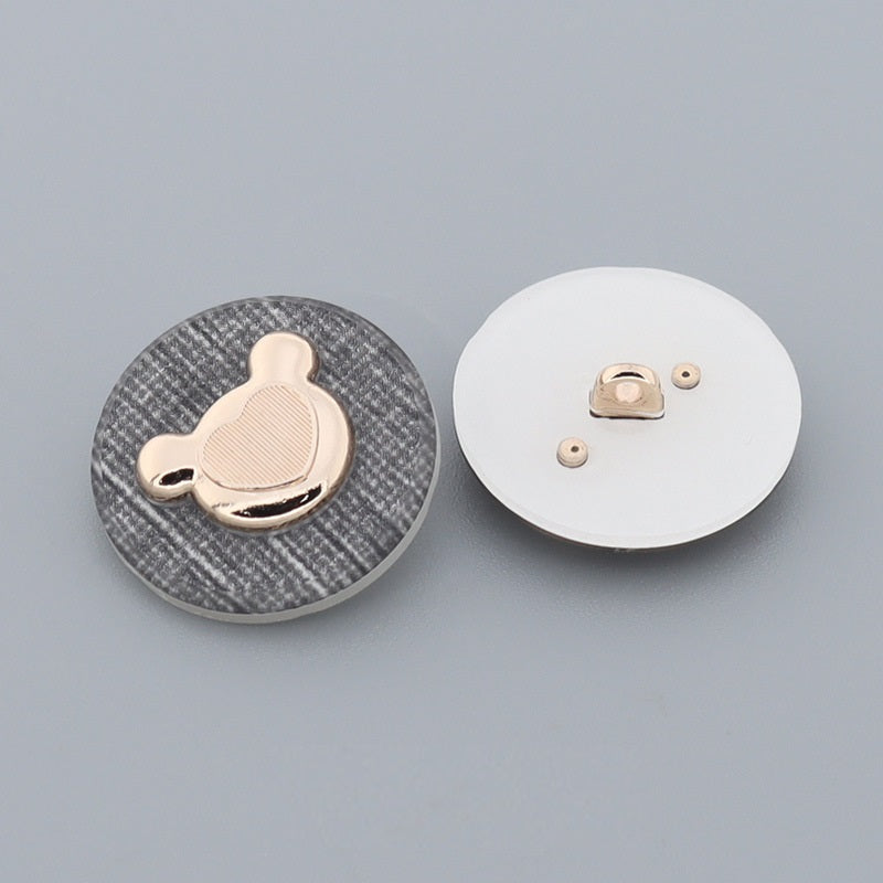 Bear-shaped metal shank button front and back on textured round backing