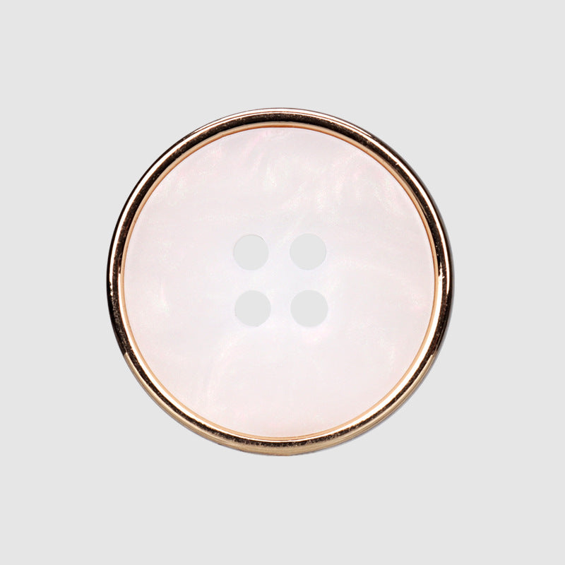 Round four-hole button, pale pink translucent resin face with gold-tone metal rim