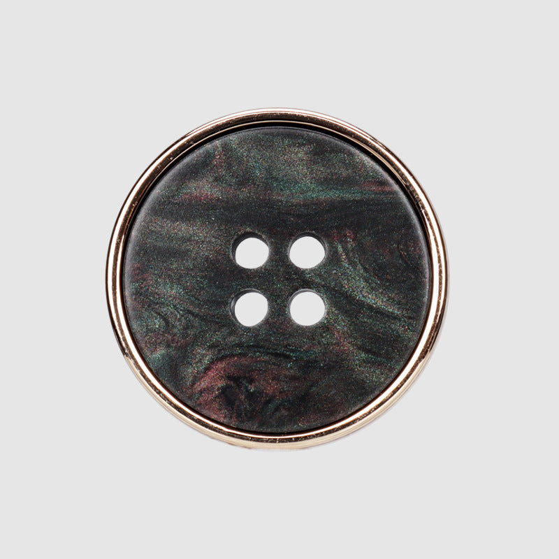 Round four-hole button, dark green-black mottled resin face with gold-tone metal rim