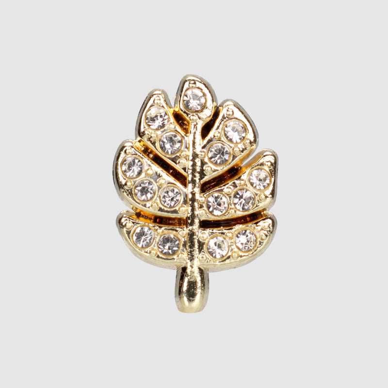 Gold leaf-shaped rhinestone metal button with sparkling stones, snap-style