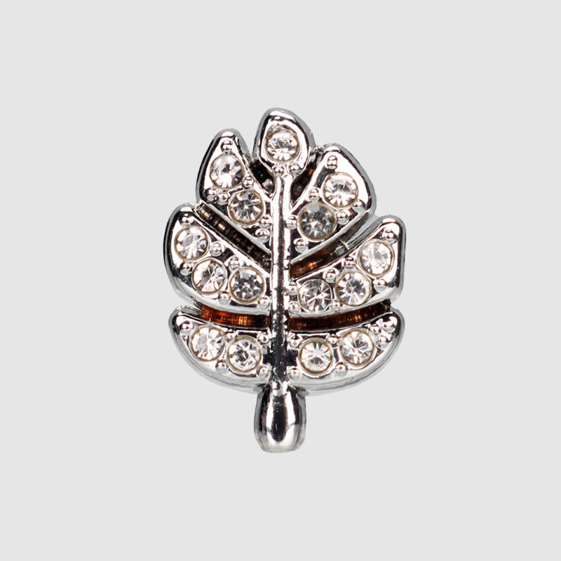 Silver leaf-shaped rhinestone metal button with sparkling stones, front view