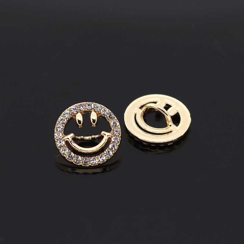 Gold circular smiley face hollow button with rhinestone ring and curved metal eyes