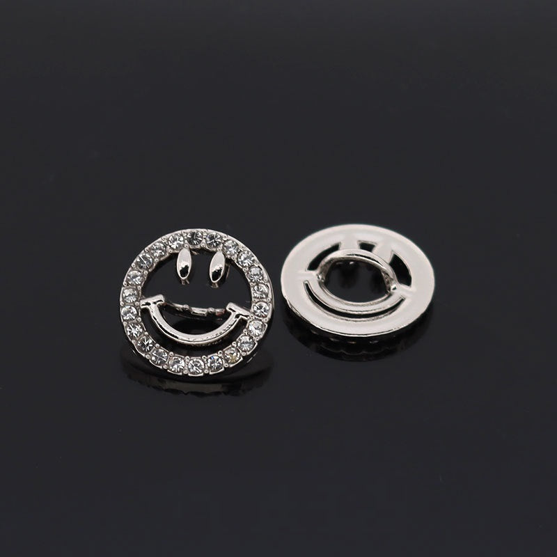 Silver circular smiley face hollow button with rhinestone ring and curved metal smile