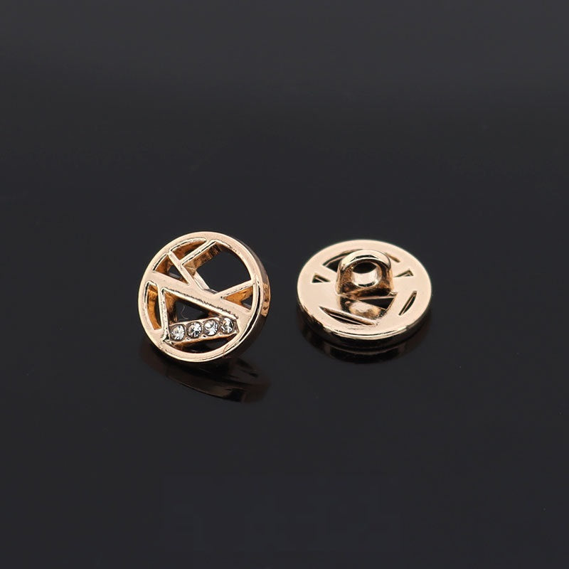 Gold circular hollow rhinestone button with star-like cutout and metal fastening post
