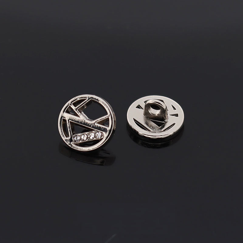 Silver circular hollow rhinestone button, star-like cutout with visible metal fastening post