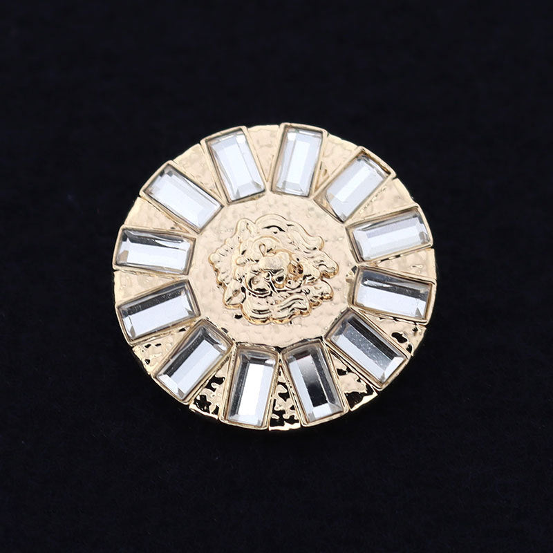 Round coat button, gold-tone metal with crystal rhinestones and engraved lion medallion