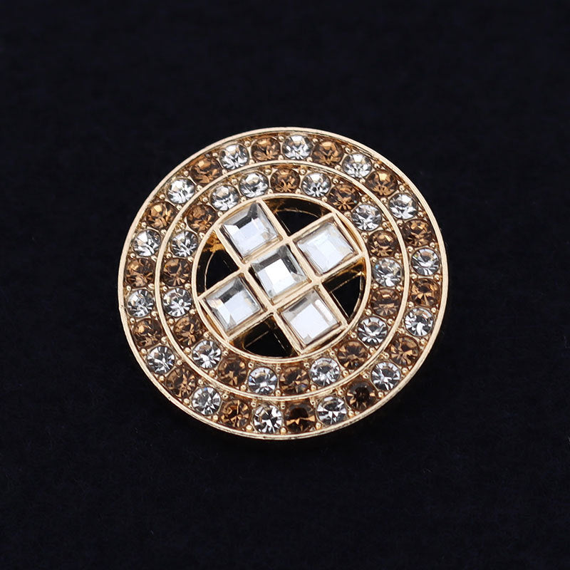 Gold-tone round coat button with circular rhinestone frame and square grid center