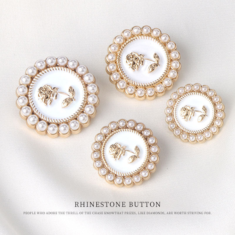 Three pearl rose metal buttons with white centers and pearl-gold edges
