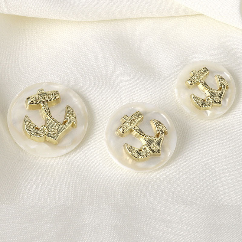 Set of four gold-tone resin anchor buttons with raised emblem