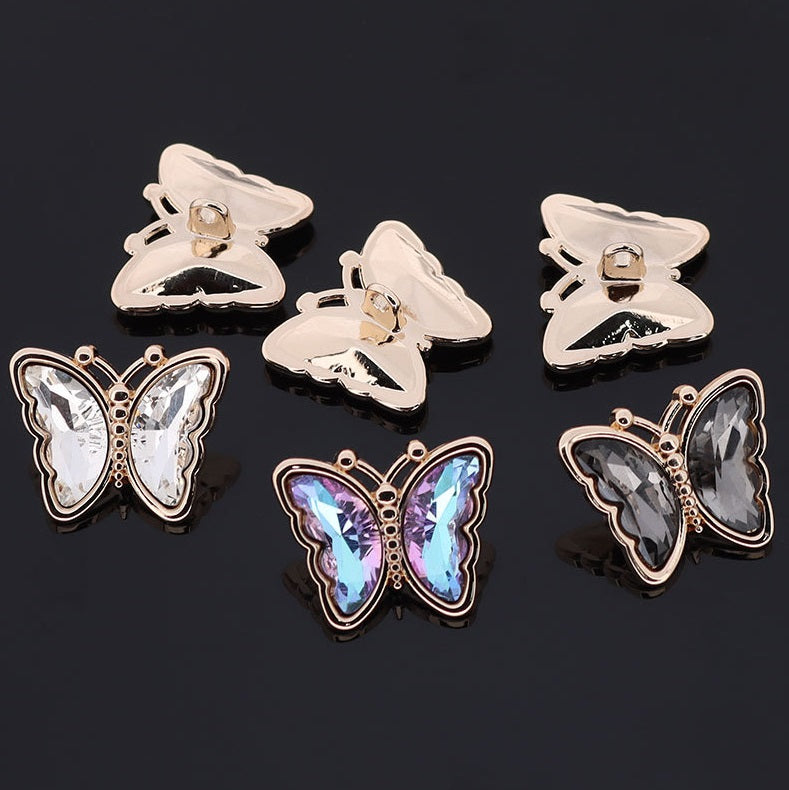 Butterfly-shaped metal rhinestone shank buttons, front stones with matching backs